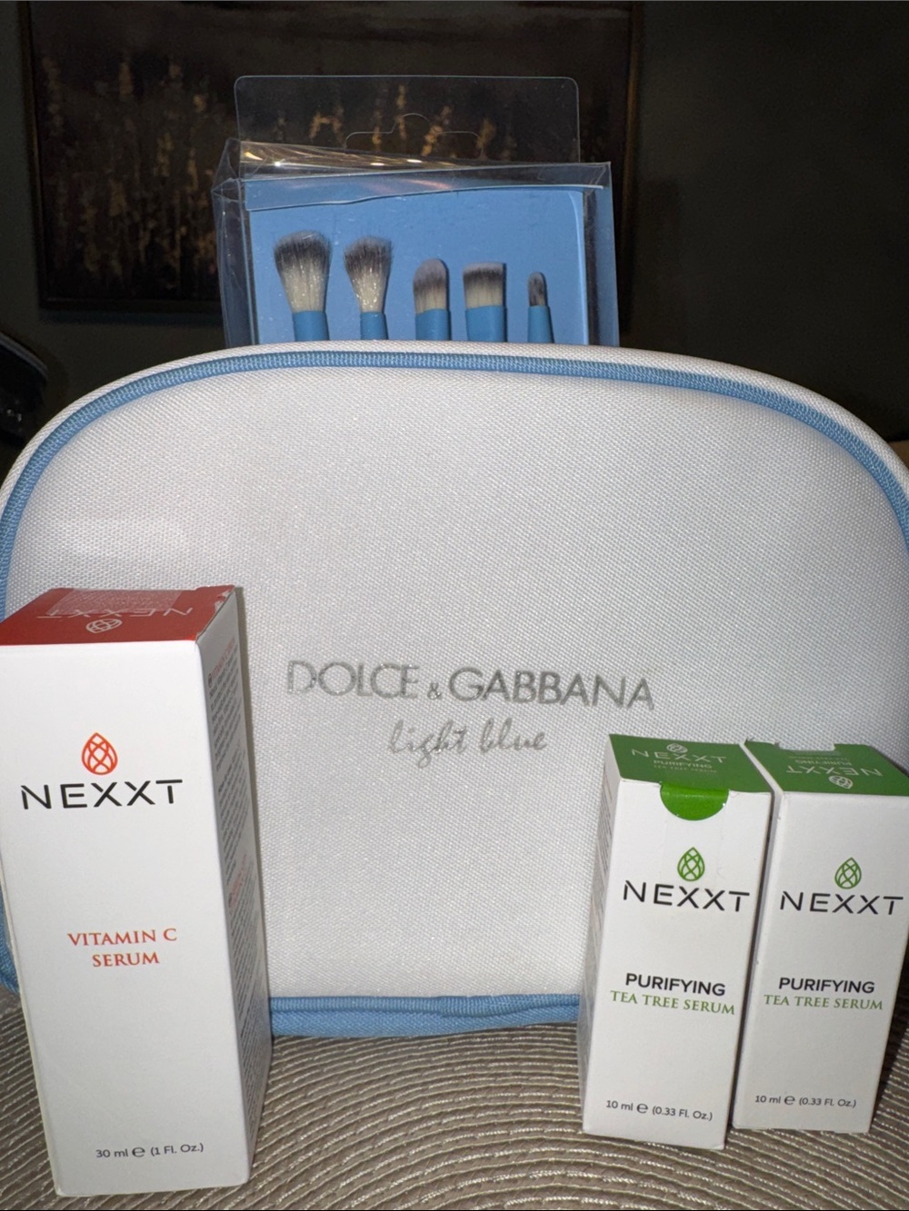 Dolce & Gabbana light blue travel cosmetic bag with skincare trio